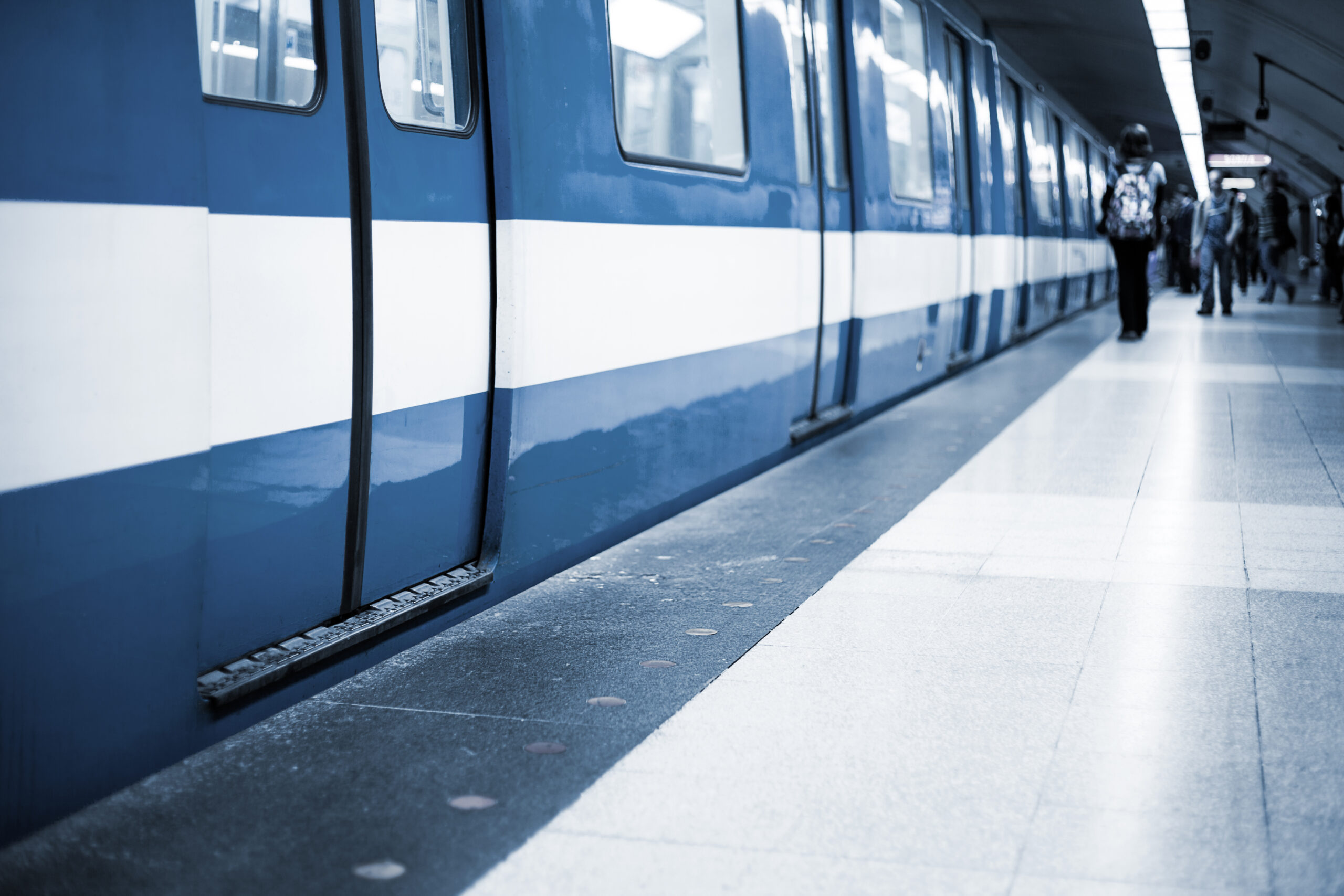 Colorful Underground Subway Train with blurry People on the Platform. Focus is on the door. room for your text.
